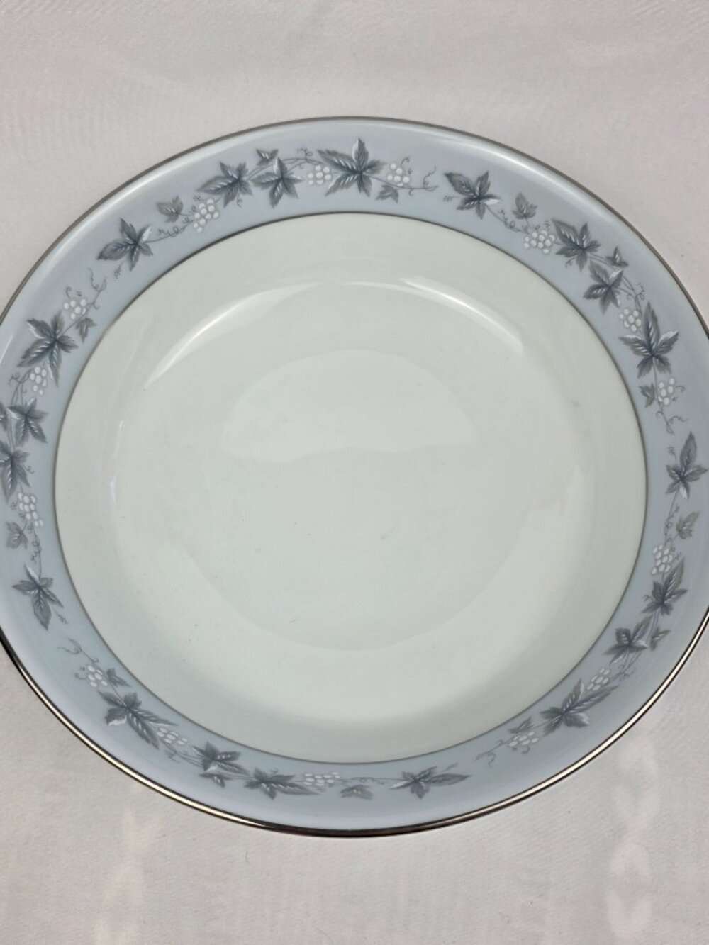 Noritake Bluecourt 9-inch oval serving bowl vegetable bowl. The bowl is white wi